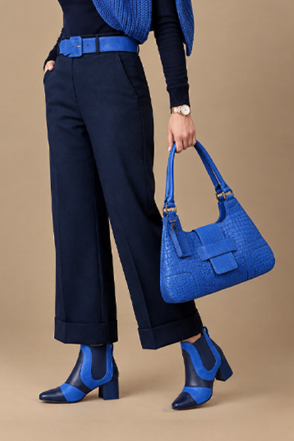 Women's navy blue and royal blue two-tone chelsea boots with round toe and low flared heel - Worn view